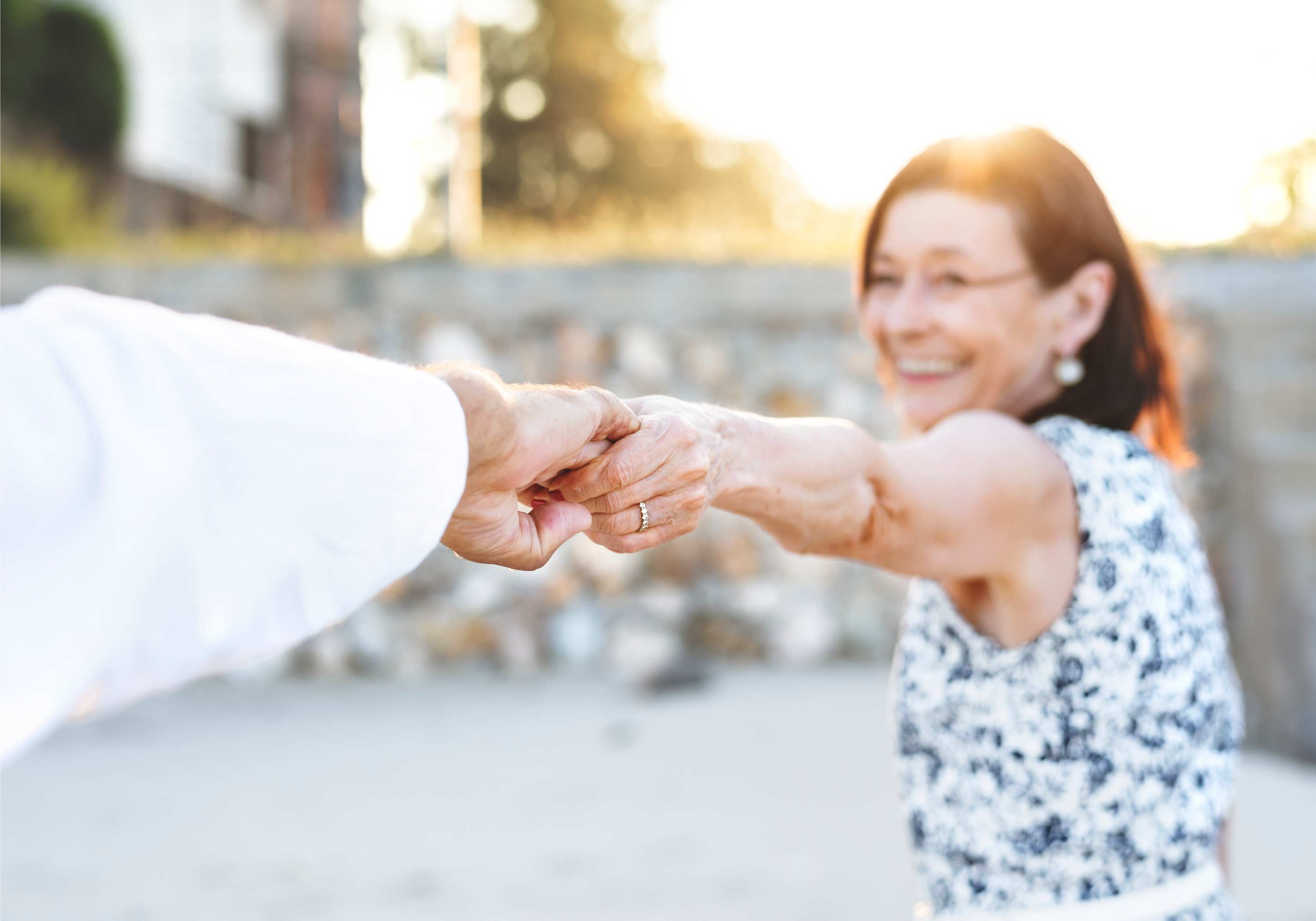 Smiling older couple dancing in the setting sun